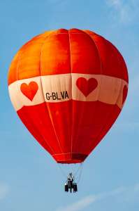Heart hot air balloon G-BLVA, an Airtour AH-31, seen at Leigh Woods, North Somerset, United Kingdom on 8 August 2014. Photograph by Dave