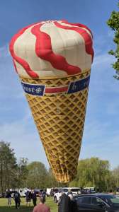 Cone hot air balloon G-BWBE, a Cameron Balloons Colt Flying ICE Cream Cone (ice cream, food). Photograph by Dave