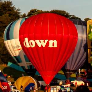 Down hot air balloon G-BZYY, a Cameron N-90 (up), seen at Leigh Woods, North Somerset, United Kingdom on 8 August 2014. Photograph by Dave