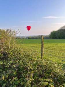 Virgin hot air balloon G-VBAX, a Cameron A-400, seen at Ashmansworth, Hampshire, United Kingdom on 7 May 2024. Photograph by brad-ox
